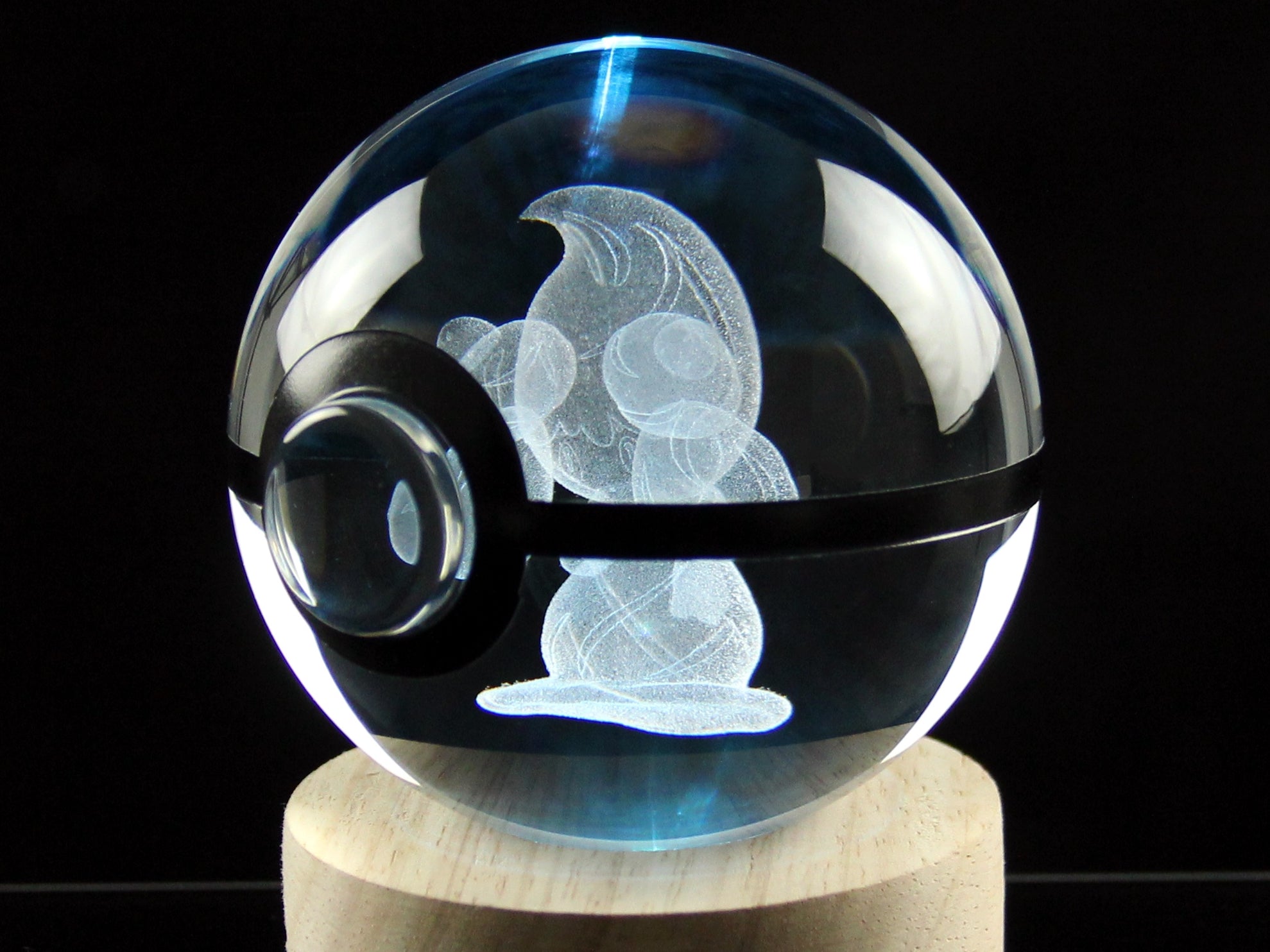Close up of Alcremie Crystal Pokeball on wooden Led base